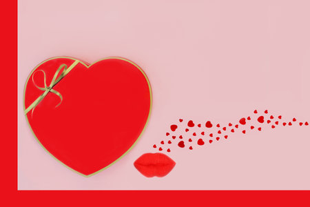Heart shaped gift box, luscious red lips and decorative confetti hearts on pink with red border background. Abstract surreal Valentines day, birthday, anniversary design concept.の写真素材