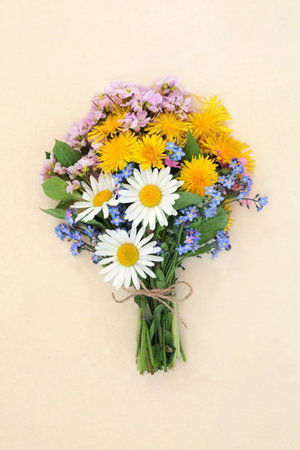Spring wildflower bouquet tied with string bow on hemp paper background. Floral nature Beltane composition of European and British flowers.の写真素材