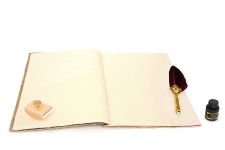 Ancient stationery vintage writing equipment with feather quill pen, hemp notebook blotter, ink bottle on white. Old fashioned letter, document, journal, manuscript concept.の写真素材