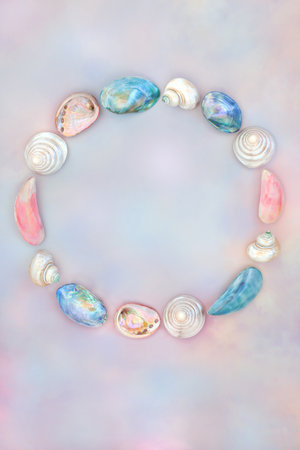 Mother of pearl and sea shell wreath decoration on rainbow sky background. Seaside summer art design for logo or greeting card.の写真素材