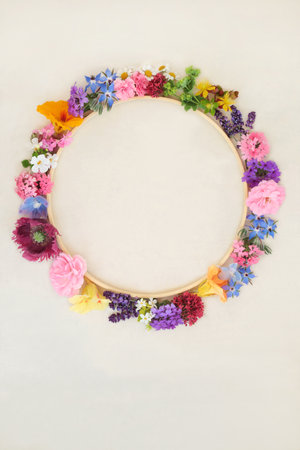 Flower and herb wreath used in naturopathic herbal medicine. Flower essences for alternative remedies and aromatherapy essential oil on hemp paper.の写真素材