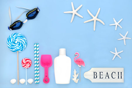 Summer holiday suntan lotion, swimming goggles, beach sign, accessories, symbols and decorations. Fun travel tourism vacation concept on pastel blue background.の写真素材