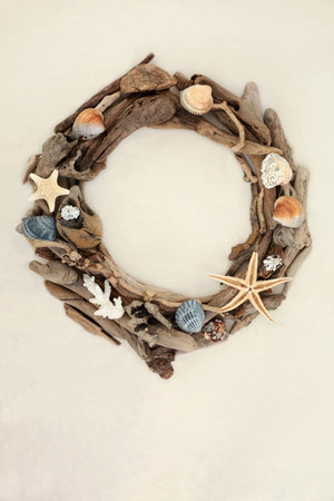 Driftwood and seashell wreath abstract frame on hemp paper background. Natural wood nature compositon.の写真素材