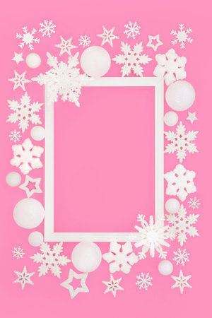 Christmas festive snowflake star decorations magical background border on pink, white frame. Festive design for Noel, Yule Xmas holiday season. Gift tag, label, greeting card.の写真素材