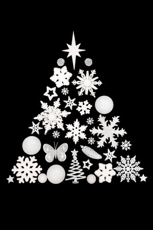 Christmas tree concept shape with white glitter bauble decorations on black background. Surreal design with snowflake, star,  pinecone, butterfly ornaments.の写真素材