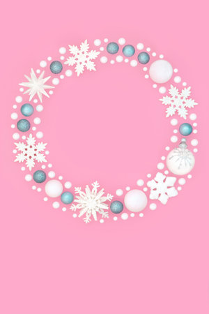 Fantasy Christmas white snowflake star blue glitter bulb wreath decoration on pink background. Festive beautiful garland for Yule, Noel Xmas, greeting card, gift tag, label.の写真素材