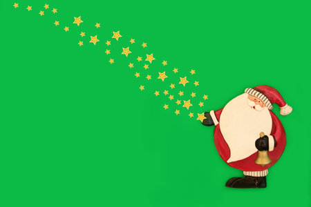 Christmas Eve magical Santa Claus retro decoration with gold stars on green background, Traditional fantasy symbol for the festive holiday season. Copy space.の写真素材