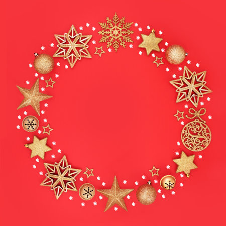 Christmas gold wreath decoration with snowflakes and glitter baubles on red background. Xmas Yule garland design for greeting card, gift tag, label.の写真素材