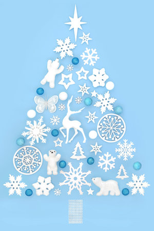 Christmas tree magical abstract shape with reindeer, polar bear, white snowflake and baubles. North Pole theme on blue background. Festive design for Xmas, Yule Noel.の写真素材