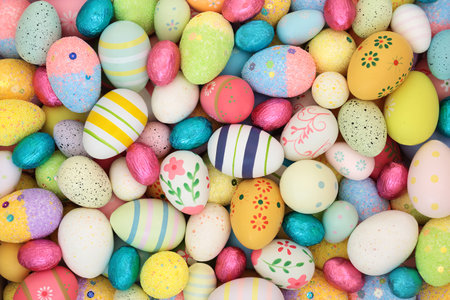 Easter egg background with large collection of decorated and foil wrapped eggs. Edible sweet...