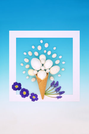 Abstract Easter egg ice cream cornet with spring flowers, white frame background on gradient blue. Surreal design for holiday season greeting card.の写真素材