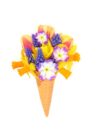 Surreal Spring ice cream cone with flowers of tulips, daffodils, narcissus and primroses. Fun seasonal floral symbol for greeting card.の写真素材