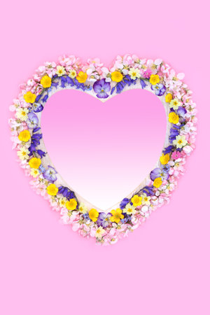 Spring Beltane floral wreath love symbol frame on pink with bluebell, apple blossom and buttercup...