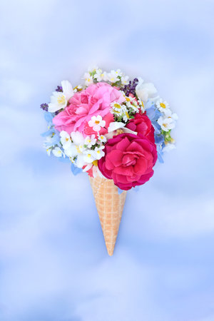 Abstract summer food art ice cream flower cornet on sky background. Whimsical surreal edible food floral fun nature design for greeting card.の写真素材