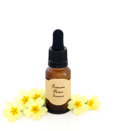 Primrose flower essence for natural herbal medicine with brown glass bottle and label on white.の写真素材