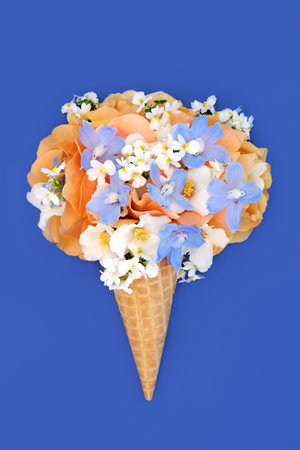 Summer flowers whimsical surreal ice cream cornet design on blue. Rose, delphinium, orange blossom, nemesia flower fun food floral design for logo or greeting card.の写真素材