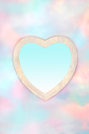 Romantic heart shape frame on paradise sky background. Abstract surreal dreamy symbol of love design for birthday, valentines, greeting card. Gradient fill blue insert.の写真素材