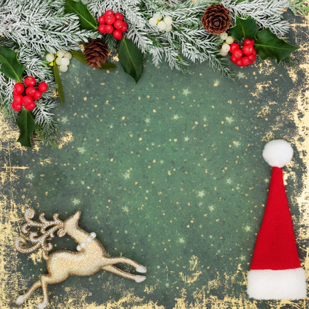 Christmas santa hat, reindeer tree decorations, holly red berries, winter flora snow fir, mistletoe on grunge green background border frame. Festive design for Xmas.の写真素材