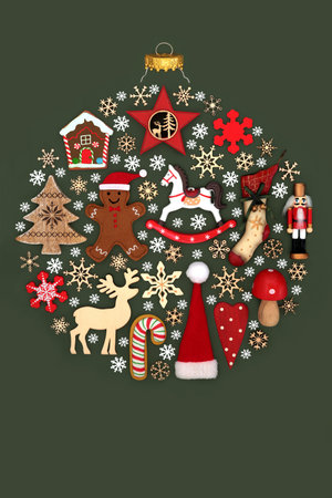 Natural old fashioned Christmas bauble sphere shape decoration with Xmas decorations, symbolic snowflakes on dark green. Festive surreal symbol.の写真素材