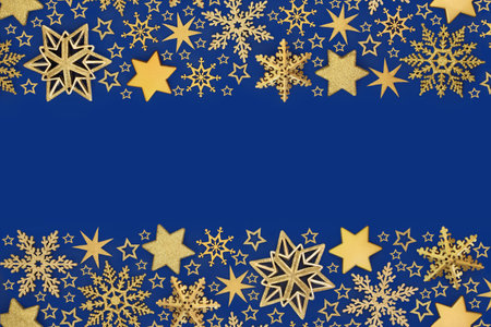Xmas luxury decorations gold star, snowflake baubles on blue background. Festive abstract design for holiday Christmas season. Greeting card.の写真素材