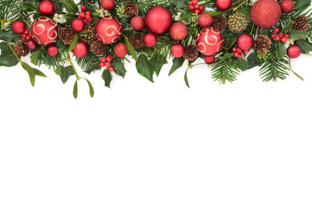 Christmas winter festive red gold bauble decorations, holly, mistletoe berries, ivy, fir, pine cones. Xmas traditional flora  border design for holiday season on white.の写真素材