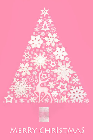 Christmas tree concept shape with white reindeer bauble,  snowflake, star, ball bauble decorations on pink. Festive abstract design for holiday season. Phrase.の写真素材