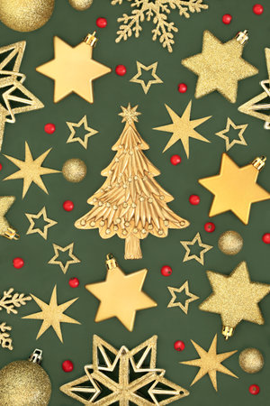 Christmas tree gold snowflake, star, sphere decorations, red holly berries on green. Festive abstract bauble design for Xmas holiday season.の写真素材