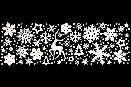 Xmas banner white reindeer, snowflakes, trees, stars, decorations, ornate festive design on black background. Abstract style for Christmas holiday season.の写真素材