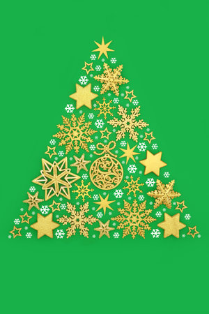 Christmas tree concept shape with gold bauble decorations, white snowflake decorations on green background. Surreal abstract symbol for festive season.の写真素材