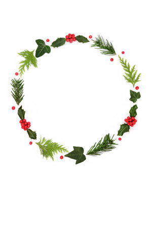 Traditional natural winter solstice nature flora wreath, holly, red berries, fir, ivy leaves on white. Festive minimal abstract design for Xmas holiday season.の写真素材