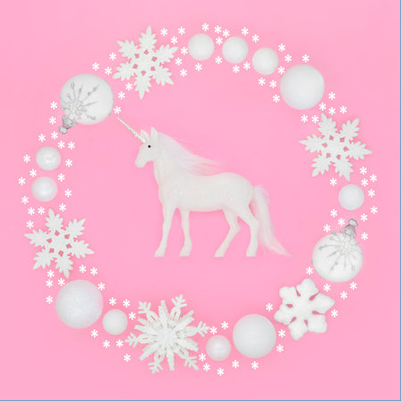 Enchanting unicorn Christmas white snowflake star glitter bulb wreath decoration on pink background, Festive magical garland for Yule, Noel Xmas, greeting card, gift tag, label.の写真素材