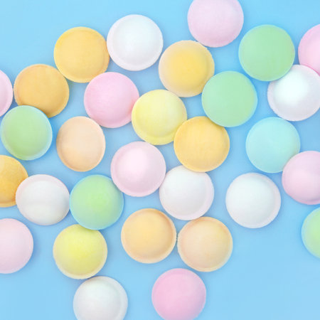 Flying saucer UFO sweet sherbet food abstract background on blue. Old fashioned confectionery fun...