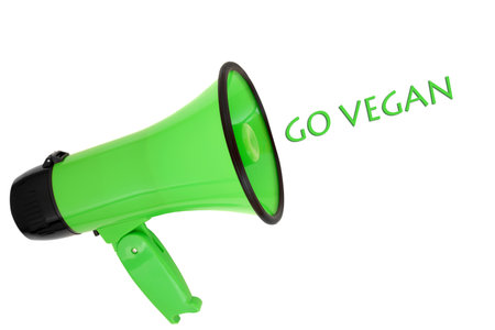 Megaphone with go vegan slogan on white background. Green issue concept for plant based foods, environmental conservation, save the earth concept.の写真素材