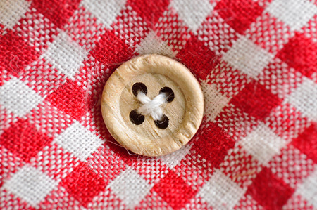 wood Button on checkered textileの写真素材