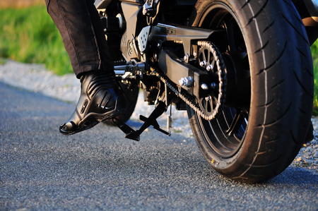 motorcycle parked on a dirt roadの写真素材