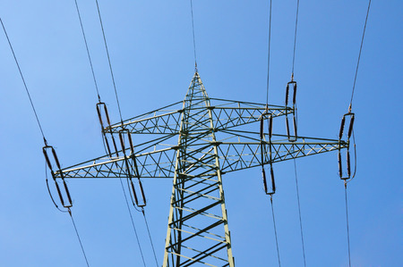 electricity pylon against blue skyの写真素材