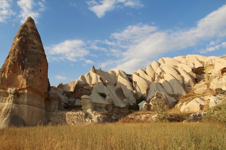 Natural valley with volcanic tuff stone rocks in Goreme in Cappadocia, Central Anatolia region of Turkey, at sunset. Popular tourist destination in Turkey for trekking.の写真素材