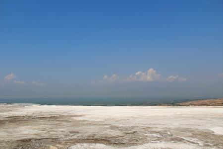 Pamukkale natural resort in Turkey, white salt hills background, snow white mountains. Pamukkale exotic pearl of Turkey, the rarest natural phenomenon.の写真素材