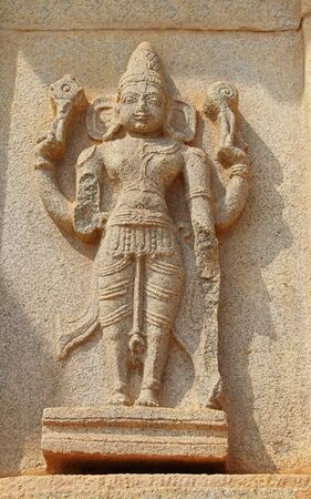 Hampi, Karnataka, India - October 20, 2017: Stone bas-reliefs on the walls around the Vittala...