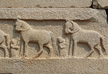 Hampi, Karnataka, India - October 20, 2017: Stone bas-reliefs on the walls around the Vittala Temple. Unesco World Heritage Site. The famous tourist destination from GOA.のeditorial素材