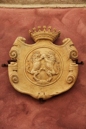 ROVINJ, CROATIA - October 07, 2019: The Venetian facade of a house with a stone coat of arms with lions and a crown in the Mediterranean village of Rovinj, Istria, Croatia. Europe.のeditorial素材