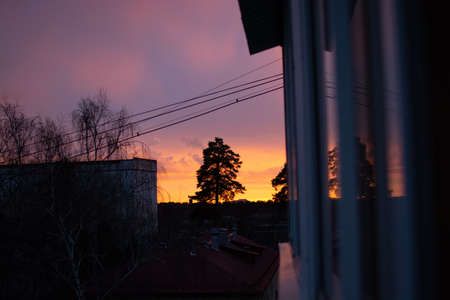 Enjoy a beautiful sunset from the Windows of a high-rise building.のeditorial素材