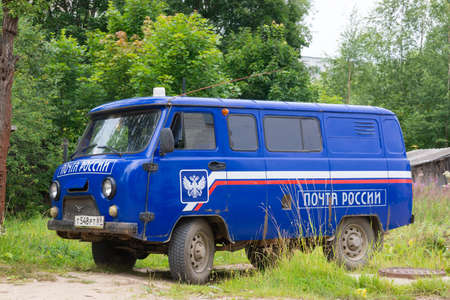 Branded blue car UAZ SGR ("Loaf") "Russian POST" stands on the street.のeditorial素材