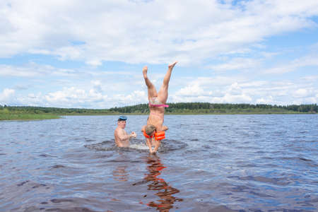 People frolic in the water on a hot Sunny summer day.の写真素材