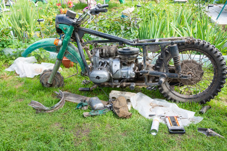 Repairs of an old motorcycle "Ural" in the summer in warm weather in the country.のeditorial素材