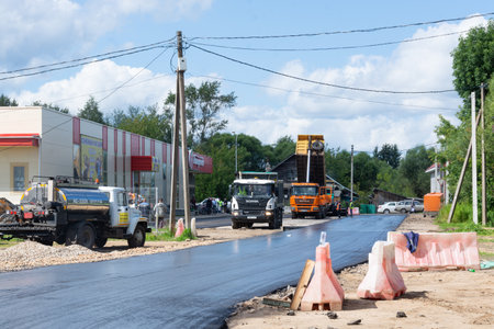 Road work on laying new asphalt near the store "Pyaterochka". Kuvshinovo, Tver oblast.のeditorial素材