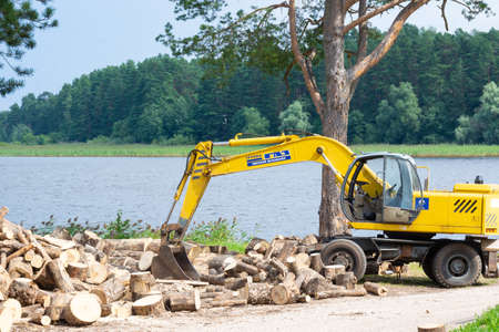 Yellow excavator-a gratuitous gift to the monastery of Nilo-Stolobenskaya Pustyn from JSC "Tver excavator". The Nile Desert. Nilo - Stolobenskaya Pustyn Monastery. Tver region.のeditorial素材