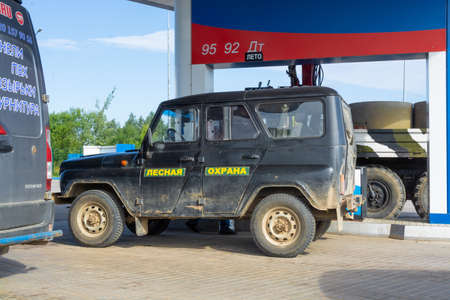 Black military jeep at the gas station.