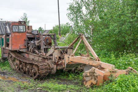 Sokolniki, Kuvshinovsky district, Tver region, Russia. Skidder. An old broken skidder stands on the side of the road.のeditorial素材