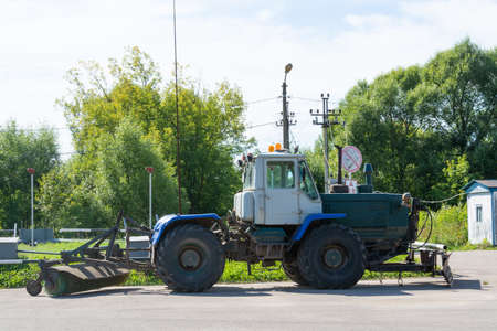 Wheeled tractor bulldozer with a blade.